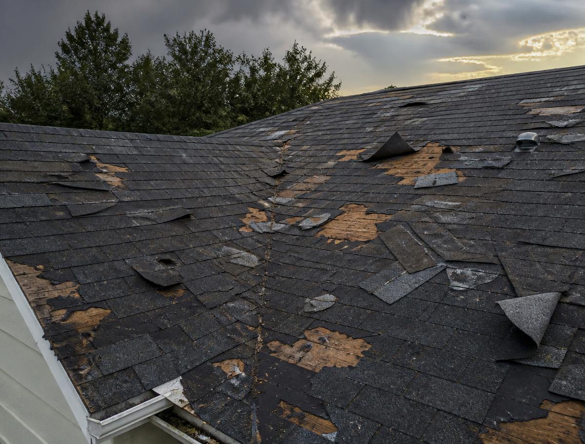 Hail and wind damaged asphalt shingles on a US home